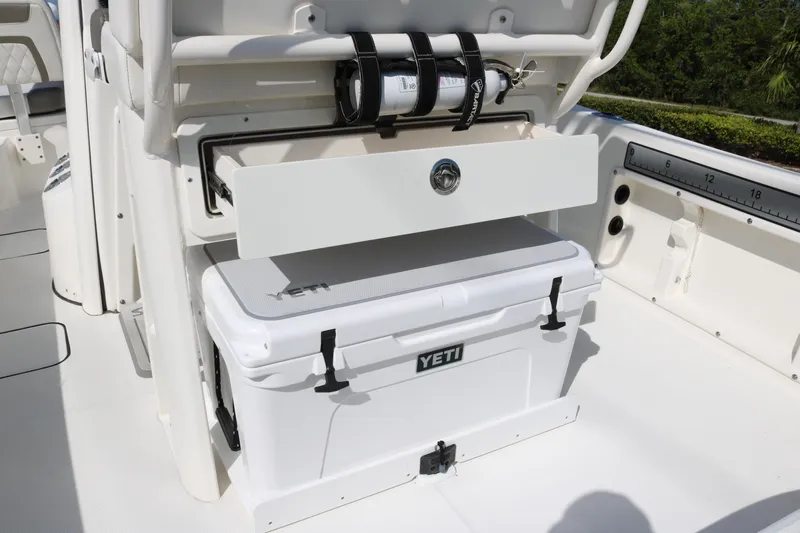 Slide: The Image of 2023 World Cat 235 CC boat interior with Yeti cooler and storage compartment. - 16