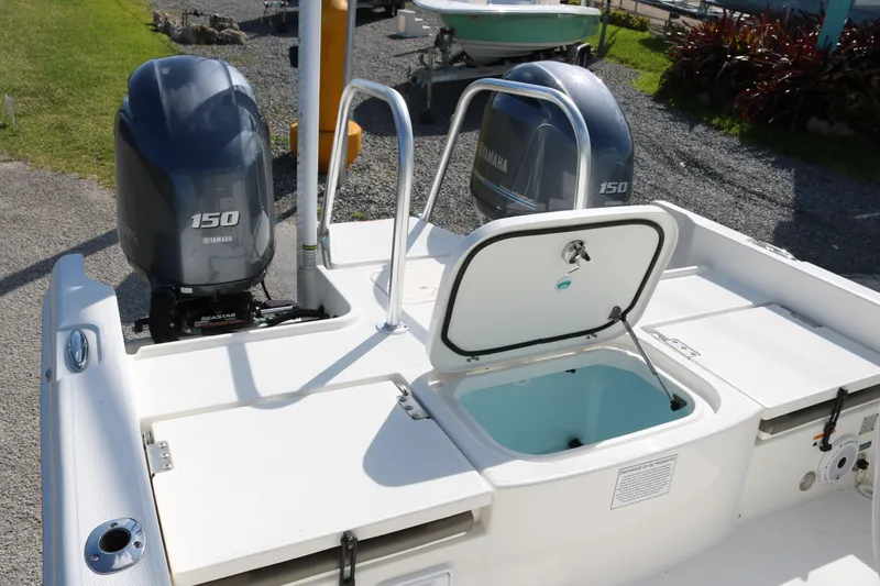 Slide: The Image of 2023 World Cat 235 CC boat with Yamaha 150 engines and open storage compartment. - 19