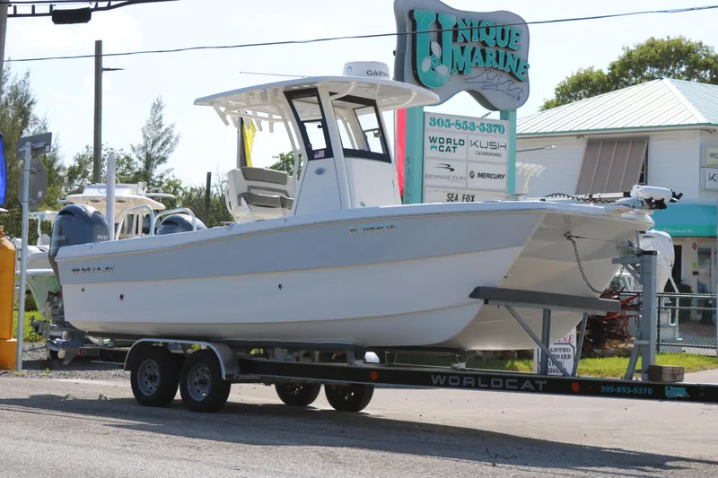 Slide: The Image of 2023 World Cat 235 CC boat on trailer at Unique Marine dealership. - 2