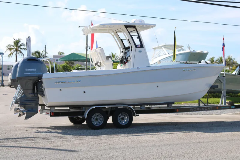 Slide: The Image of 2023 World Cat 235 CC boat on trailer with Yamaha engine, parked outdoors. - 4