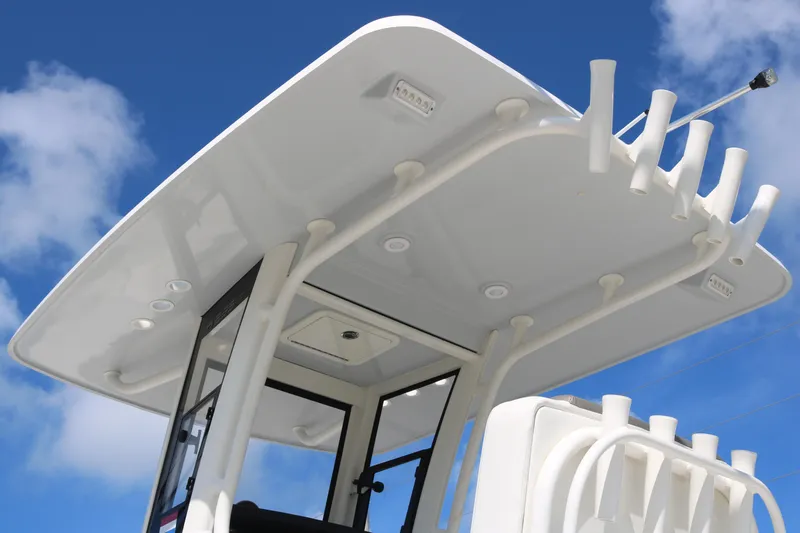 Slide: The Image of 2023 World Cat 235 CC boat's T-top against a clear blue sky. - 5