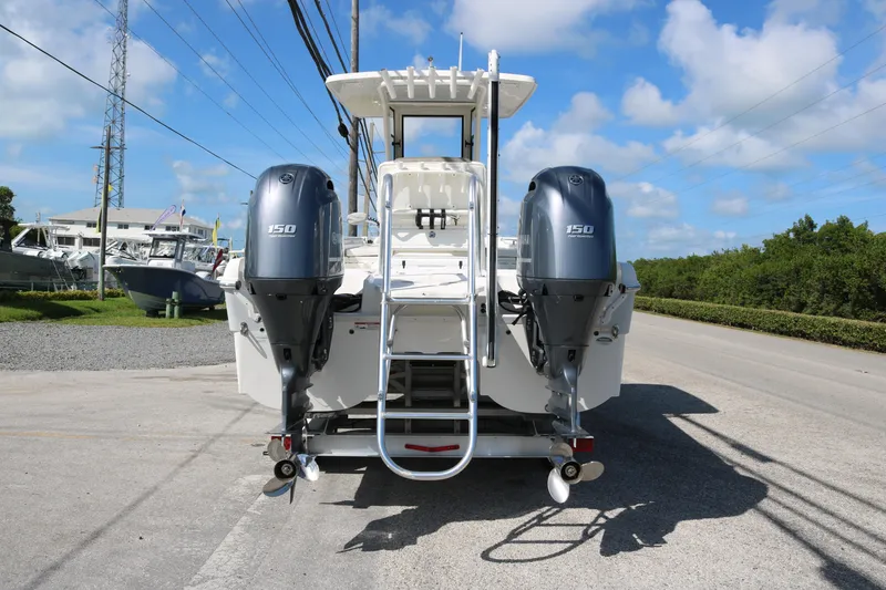 Slide: The Image of 2023 World Cat 235 CC boat with dual 150 horsepower engines, parked on a sunny day. - 6