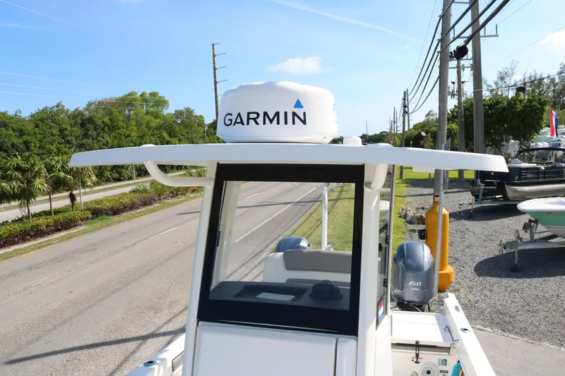 Slide: The Image of 2023 World Cat 235 CC boat with Garmin radar, parked near a road. - 7