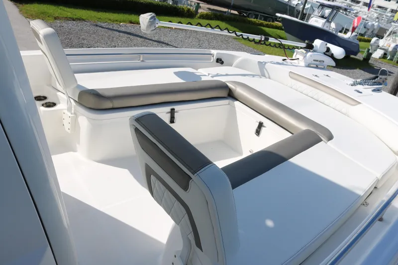 Slide: The Image of 2023 World Cat 235 CC boat interior with cushioned seating and modern design. - 9