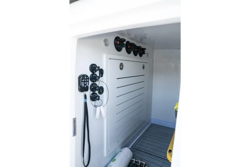 Slide: The Image of Interior view of 2025 Front Runner 43 Catamaran, showcasing control panel and storage area. - 15