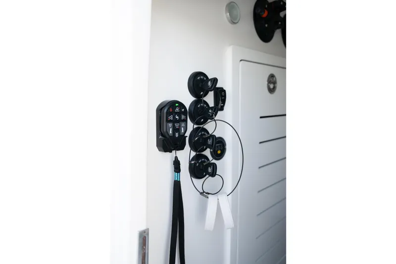 Slide: The Image of Control panel and keys on a 2025 Front Runner 43 Catamaran interior. - 16