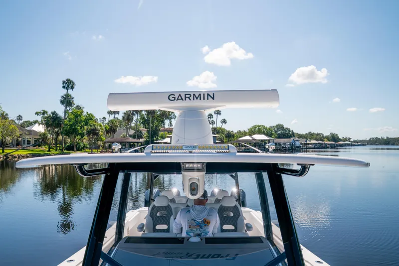 Slide: The Image of Front Runner 43 Catamaran 2025 on a serene lake with Garmin equipment. - 20