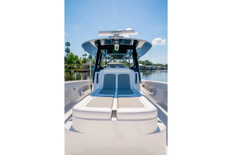 Slide: The Image of Luxurious 2025 Front Runner 43 Catamaran with plush seating, docked by a serene waterfront. - 23