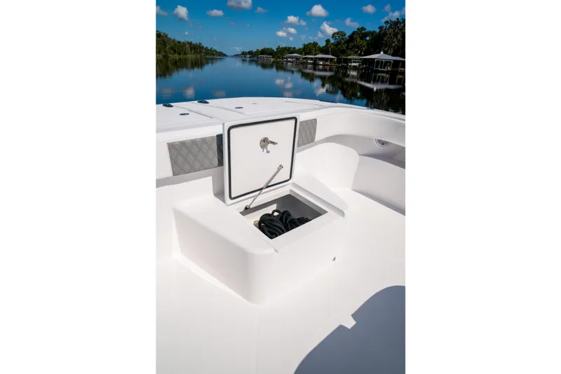 Slide: The Image of Front Runner 43 Catamaran 2025 with open storage compartment on a calm river. - 26