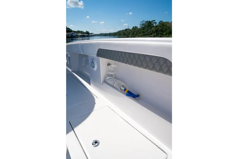 Slide: The Image of Front Runner 43 Catamaran 2025 deck detail with coiled hose and storage compartment. - 27