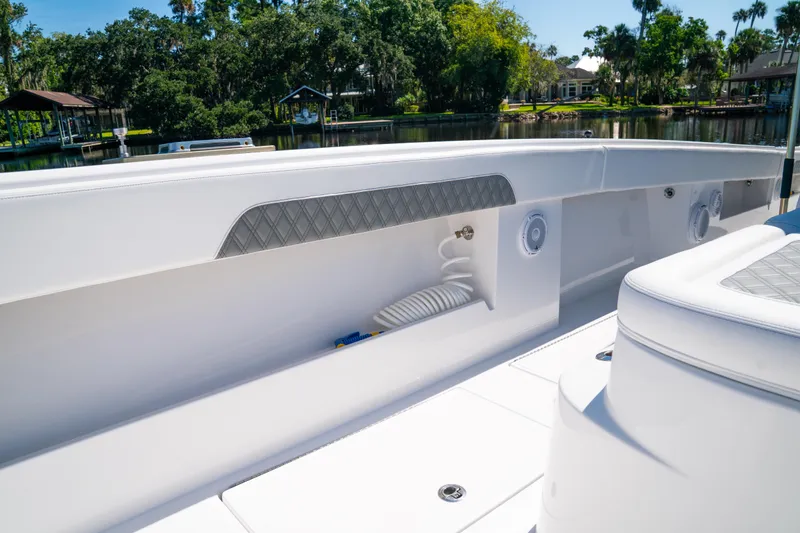 Slide: The Image of 2025 Front Runner 43 Catamaran deck with sleek seating and storage, dockside view. - 28