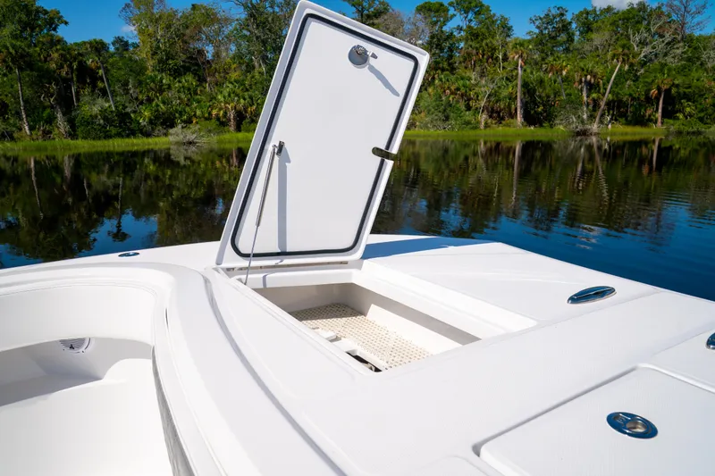 Slide: The Image of 2025 Front Runner 43 Catamaran with open hatch, reflecting serene lake and lush greenery. - 29