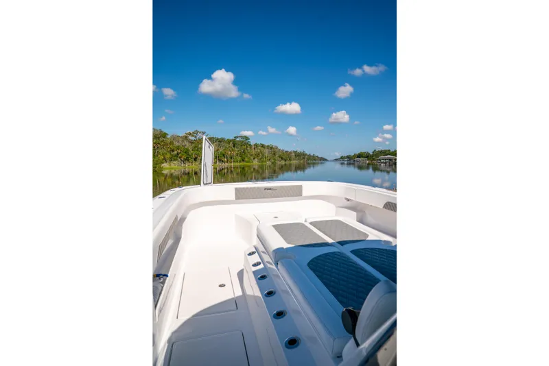 Slide: The Image of Front Runner 43 Catamaran 2025 on serene waterway under clear blue sky. - 32