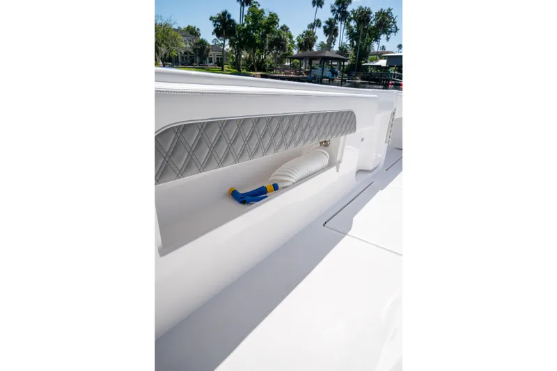 Slide: The Image of 2025 Front Runner 43 Catamaran deck detail with storage compartment and hose. - 46