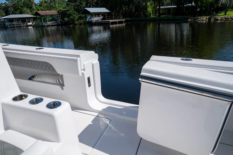 Slide: The Image of 2025 Front Runner 43 Catamaran deck view by a serene lakeside. - 47