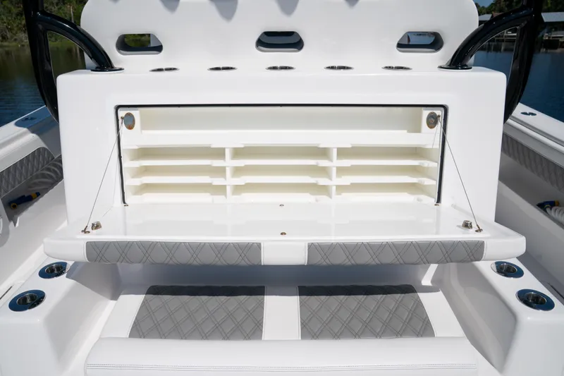 Slide: The Image of 2025 Front Runner 43 Catamaran storage compartment with cushioned seating and rod holders. - 49
