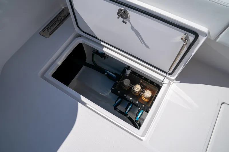 Slide: The Image of Open hatch on 2025 Front Runner 43 Catamaran, revealing internal components and storage. - 51