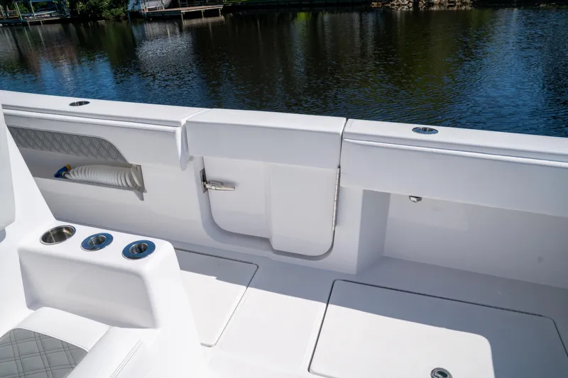 Slide: The Image of 2025 Front Runner 43 Catamaran deck with seating and cup holders by the water. - 52