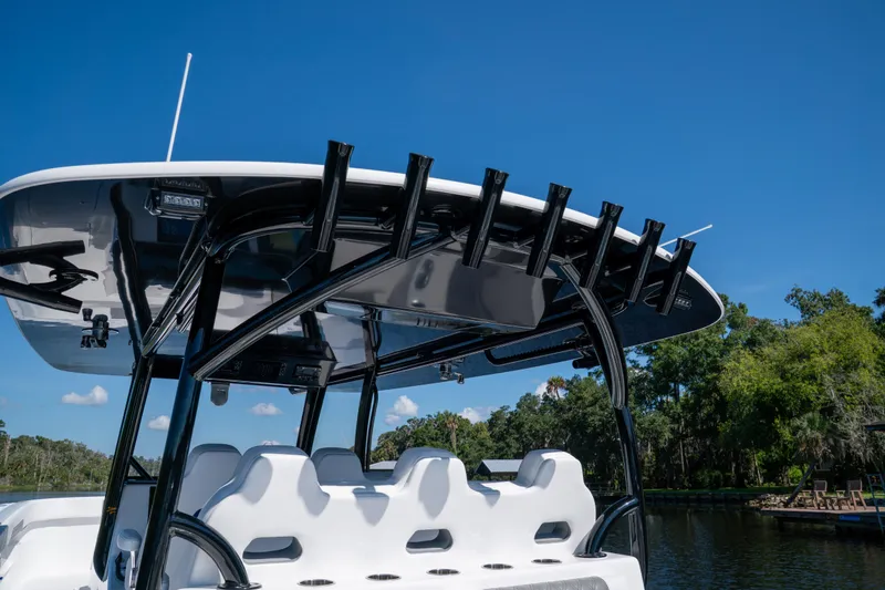 Slide: The Image of 2025 Front Runner 43 Catamaran with sleek design and rod holders, set against a clear blue sky. - 53