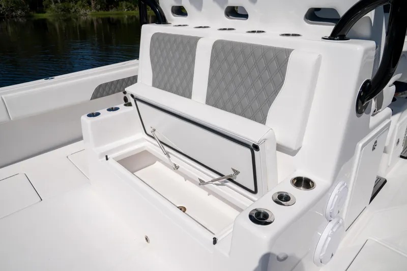 Slide: The Image of 2025 Front Runner 43 Catamaran seating area with storage compartment and cup holders. - 56