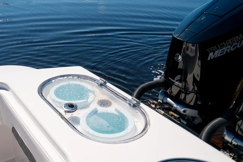Slide: The Image of Livewell and Mercury engine on 2025 Front Runner 43 Catamaran, floating on calm water. - 65