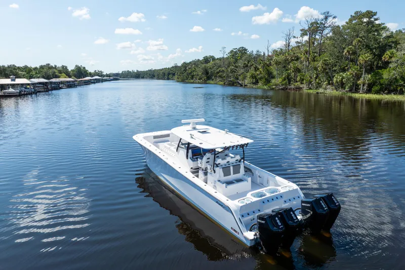 Slide: The Image of 2025 Front Runner 43 Catamaran cruising on a serene river with lush greenery. - 66