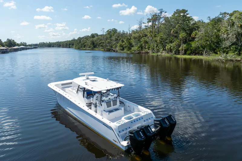 Slide: The Image of 2025 Front Runner 43 Catamaran cruising on a serene river with lush greenery. - 69