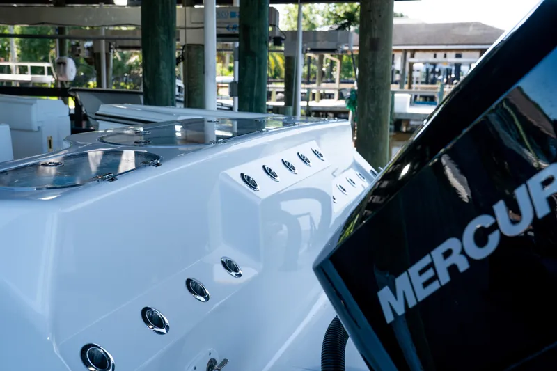 Slide: The Image of 2025 Front Runner 43 Catamaran with Mercury engine, docked in a marina setting. - 70