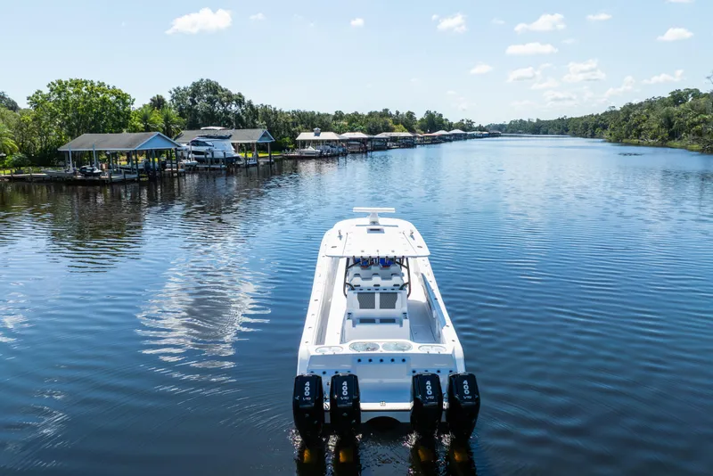 Slide: The Image of 2025 Front Runner 43 Catamaran cruising on a serene river with lush greenery. - 71