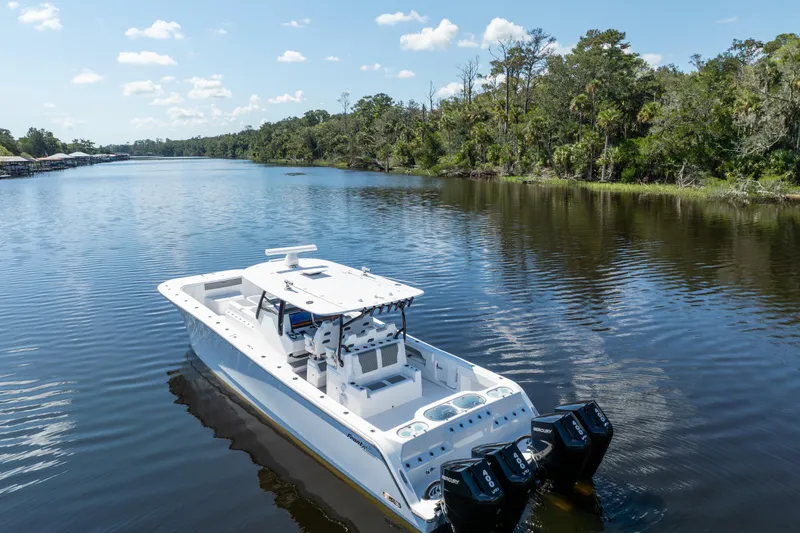 Slide: The Image of 2025 Front Runner 43 Catamaran cruising on a serene river with lush greenery. - 72