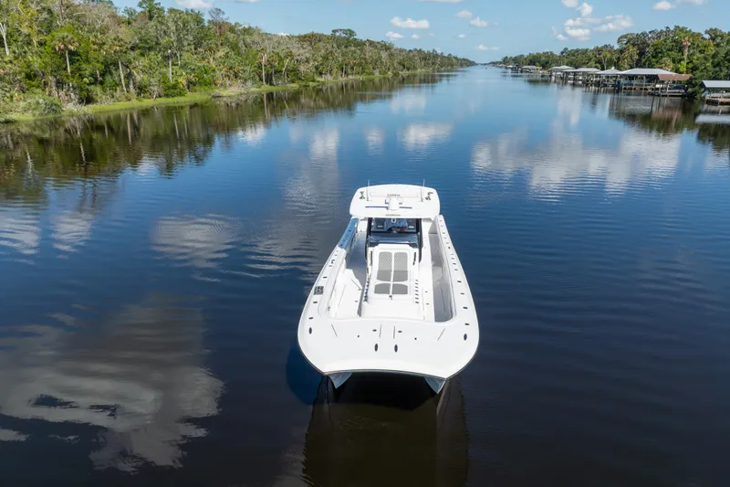 Slide: The Image of 2025 Front Runner 43 Catamaran cruising on a serene river, surrounded by lush greenery. - 73
