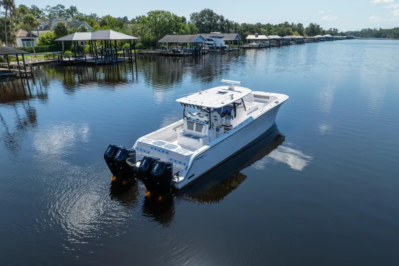 Slide: The Image of 2025 Front Runner 43 Catamaran on calm water, surrounded by docks and greenery. - 75