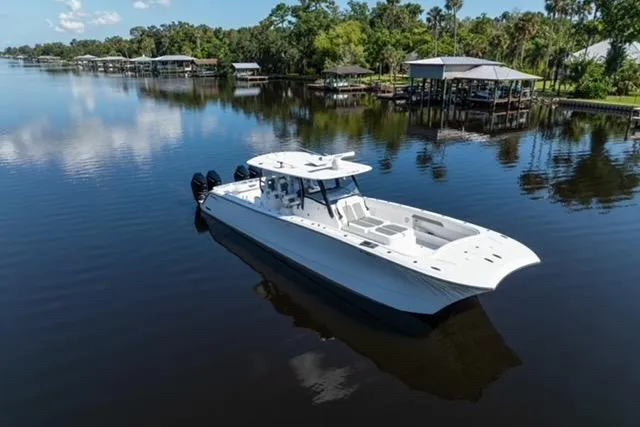 Slide: The Image of 2025 Front Runner 43 Catamaran on serene river with lush greenery. - 82