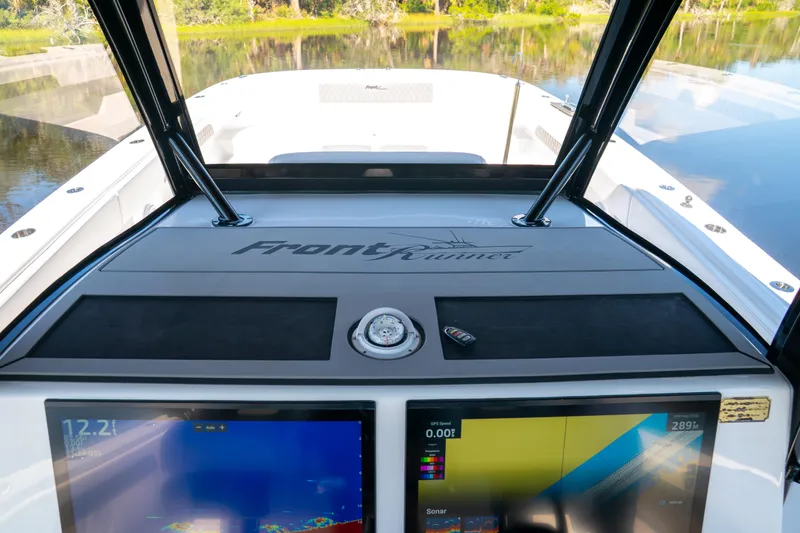 Slide: The Image of Cockpit view of 2025 Front Runner 43 Catamaran with navigation screens and compass. - 9