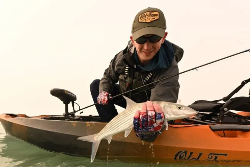 The Image of Man holding fish on Old Town Sportsman Autopilot 136 kayak, 2023 model. - 0