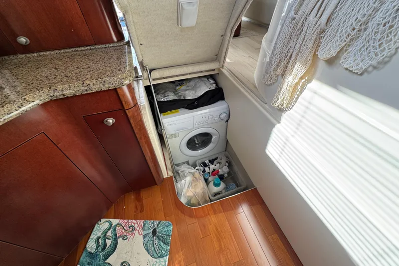 Slide: The Image of Laundry area with washing machine in 2006 Sea Ray 44 Sedan Bridge yacht. - 11
