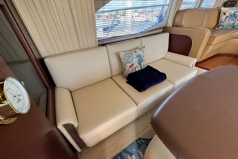 Slide: The Image of Luxurious interior of 2006 Sea Ray 44 Sedan Bridge with beige seating and decorative pillows. - 13