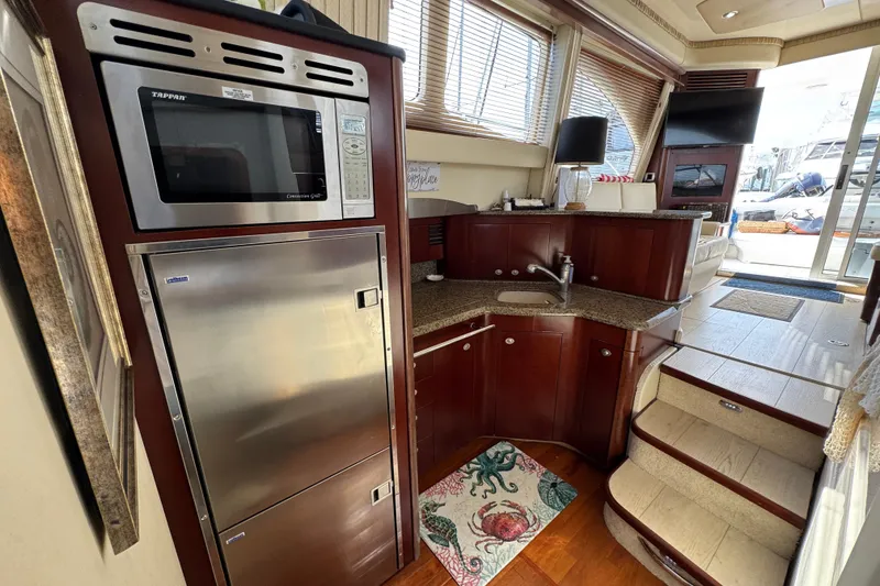 Slide: The Image of Luxurious 2006 Sea Ray 44 Sedan Bridge yacht interior with modern kitchen amenities. - 19