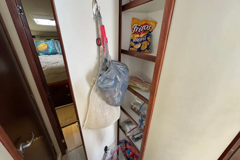 Slide: The Image of Interior of 2006 Sea Ray 44 Sedan Bridge with snacks and storage shelves. - 20
