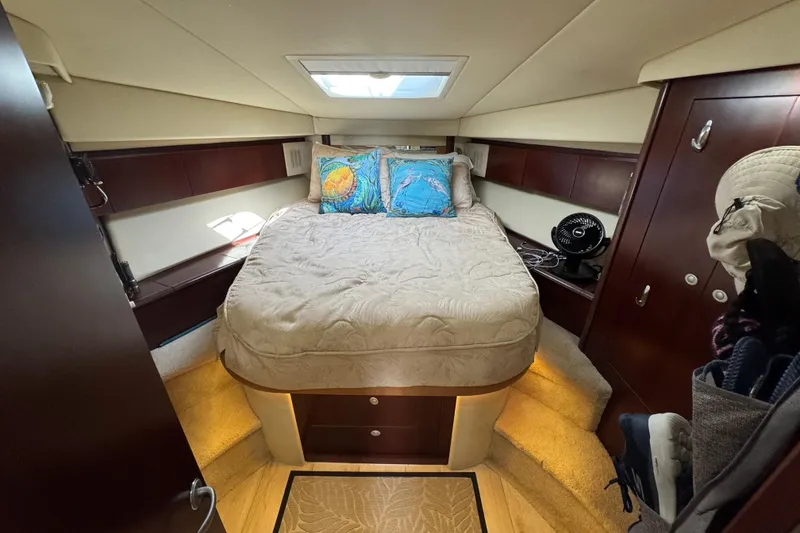 Slide: The Image of Luxurious cabin interior of a 2006 Sea Ray 44 Sedan Bridge yacht with cozy bedding. - 21
