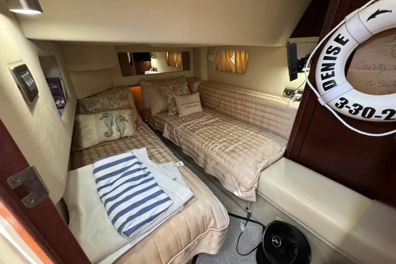 Slide: The Image of Interior cabin of 2006 Sea Ray 44 Sedan Bridge with cozy twin beds and nautical decor. - 24