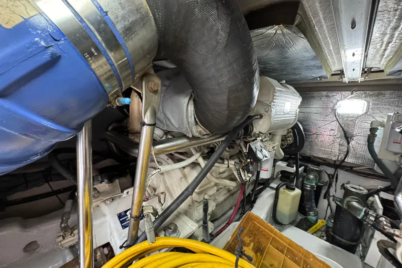 Slide: The Image of Engine room of a 2006 Sea Ray 44 Sedan Bridge, showcasing mechanical components and wiring. - 25