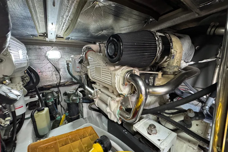 Slide: The Image of Engine room of a 2006 Sea Ray 44 Sedan Bridge yacht, showcasing mechanical components. - 26