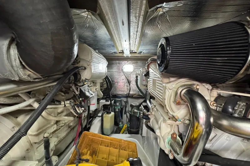 Slide: The Image of Engine room of a 2006 Sea Ray 44 Sedan Bridge yacht, showcasing mechanical components. - 28