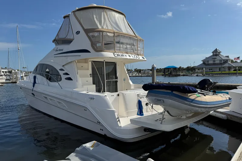 Slide: The Image of 2006 Sea Ray 44 Sedan Bridge yacht docked at marina with inflatable boat. - 3