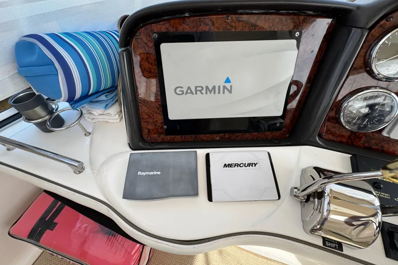 Slide: The Image of Control panel of a 2006 Sea Ray 44 Sedan Bridge with Garmin, Raymarine, and Mercury equipment. - 34