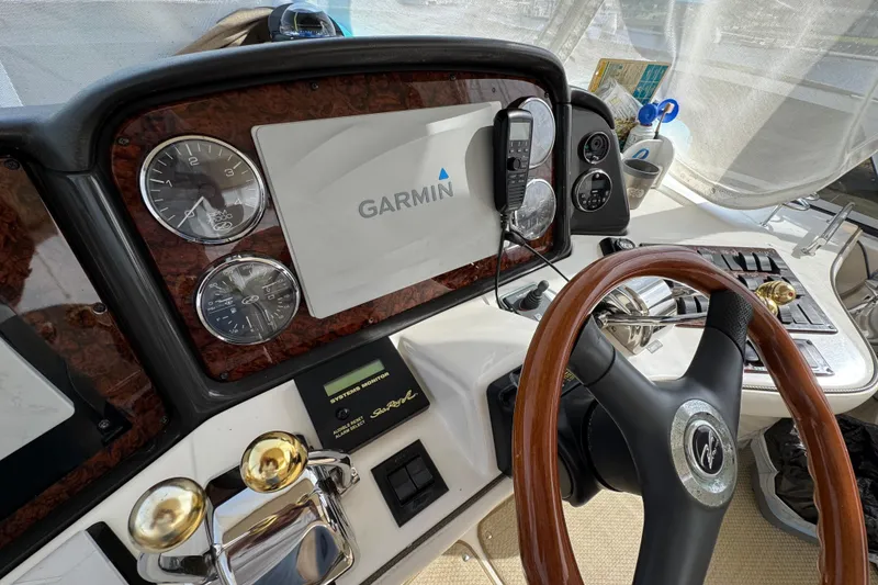 Slide: The Image of Helm of 2006 Sea Ray 44 Sedan Bridge with Garmin navigation system and wood-accented steering wheel. - 35