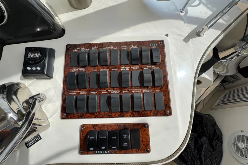 Slide: The Image of Control panel of a 2006 Sea Ray 44 Sedan Bridge yacht with labeled switches. - 36