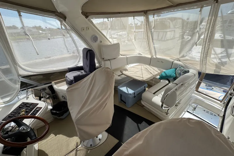 Slide: The Image of Interior of 2006 Sea Ray 44 Sedan Bridge yacht with helm, seating, and panoramic windows. - 37