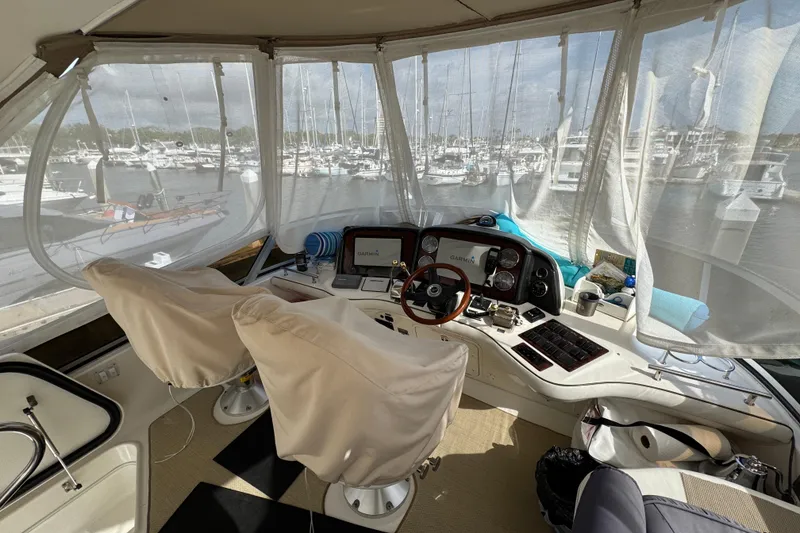 Slide: The Image of Interior helm of 2006 Sea Ray 44 Sedan Bridge with marina view. - 38